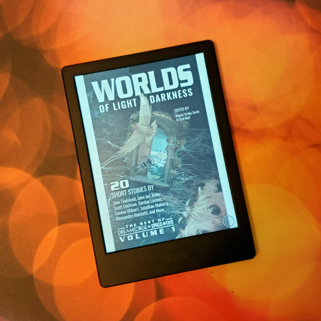 Another shot of the eReader with the cover of Worlds of Light and Darkness anthology.